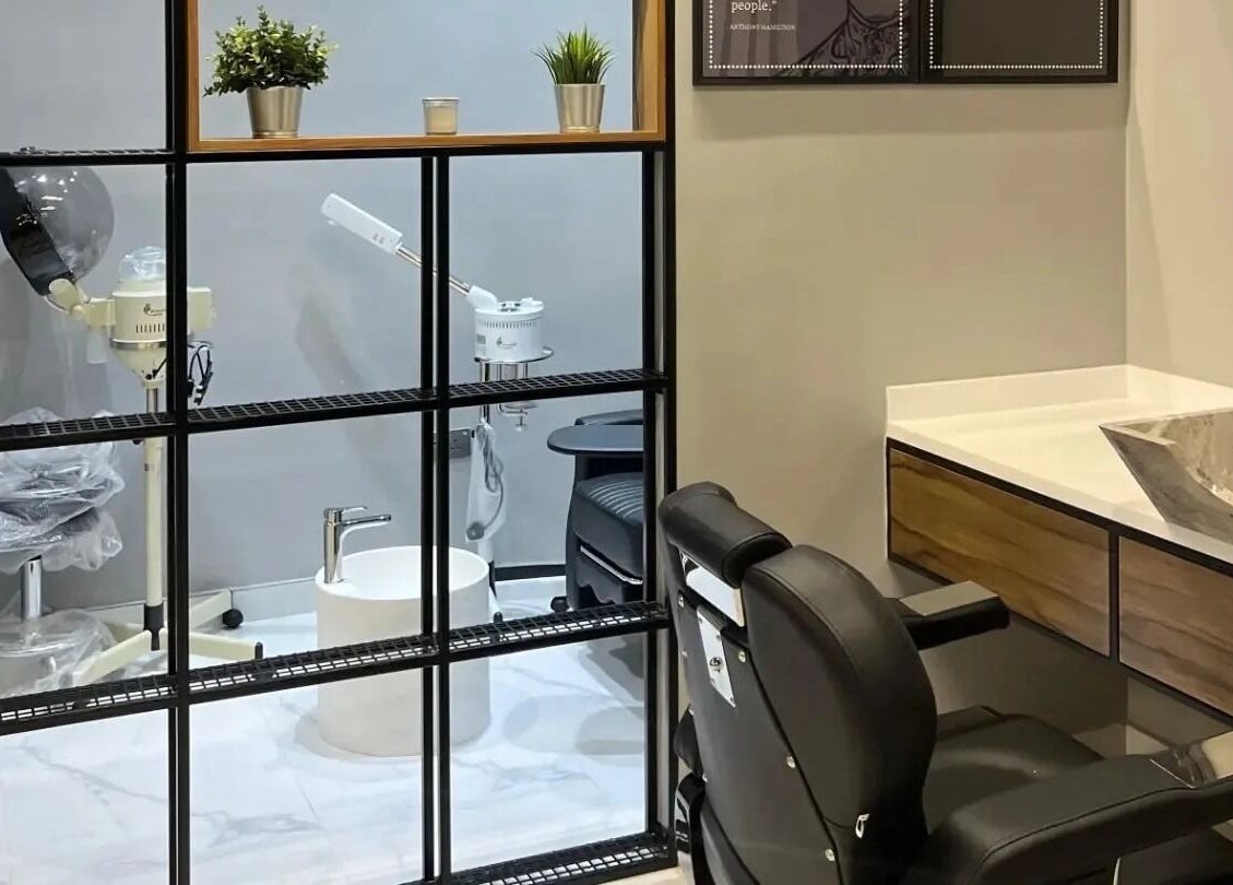 Modern salon space at Yousef Afandi-Shiekh Zayed, Giza Governorate, EG with sleek hair styling chair and wash basin.
