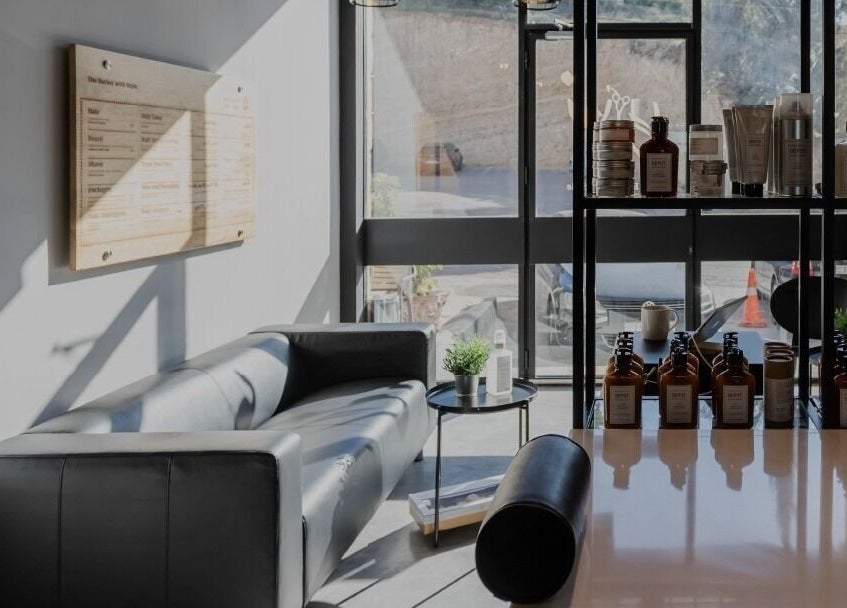 Relaxing lounge at Yousef Afandi-Shiekh Zayed, Giza Governorate, EG with sleek decor and beauty products.