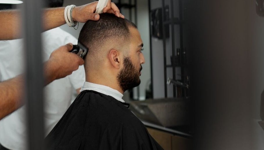 Barber giving a precise haircut at Yousef Afandi Express- Madina Nasr, Giza Governorate, Giza Governorate, EG.