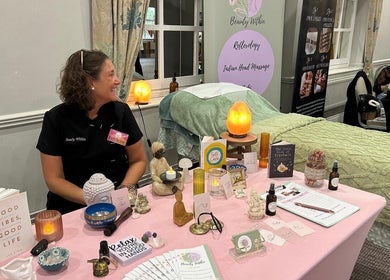 Beauty Within booth at Hull, England, GB, showcasing wellness products and massage table.