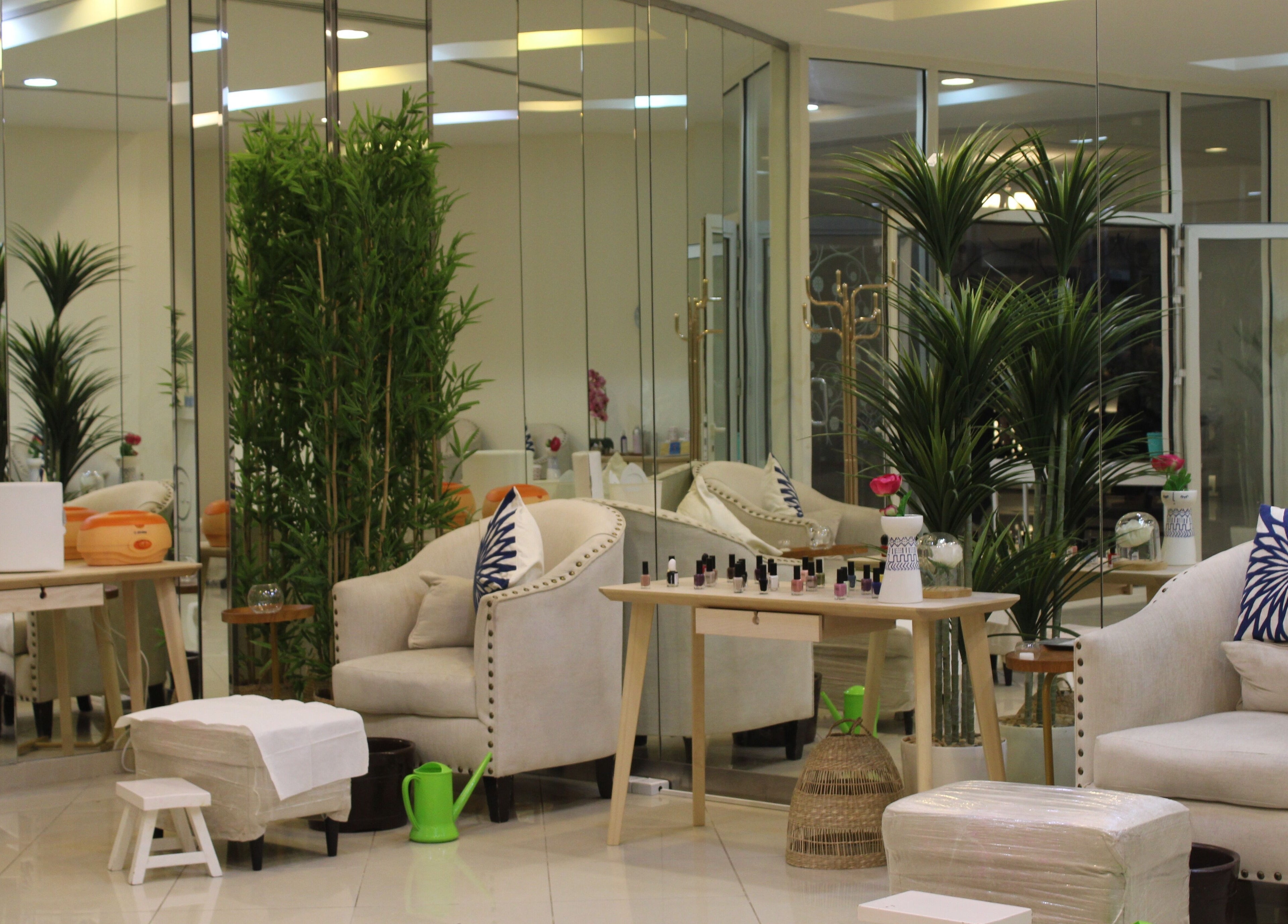 Elegant interior of Can Beauty Salon | Hayel, Hayel, SA, featuring plush chairs and vibrant greenery.