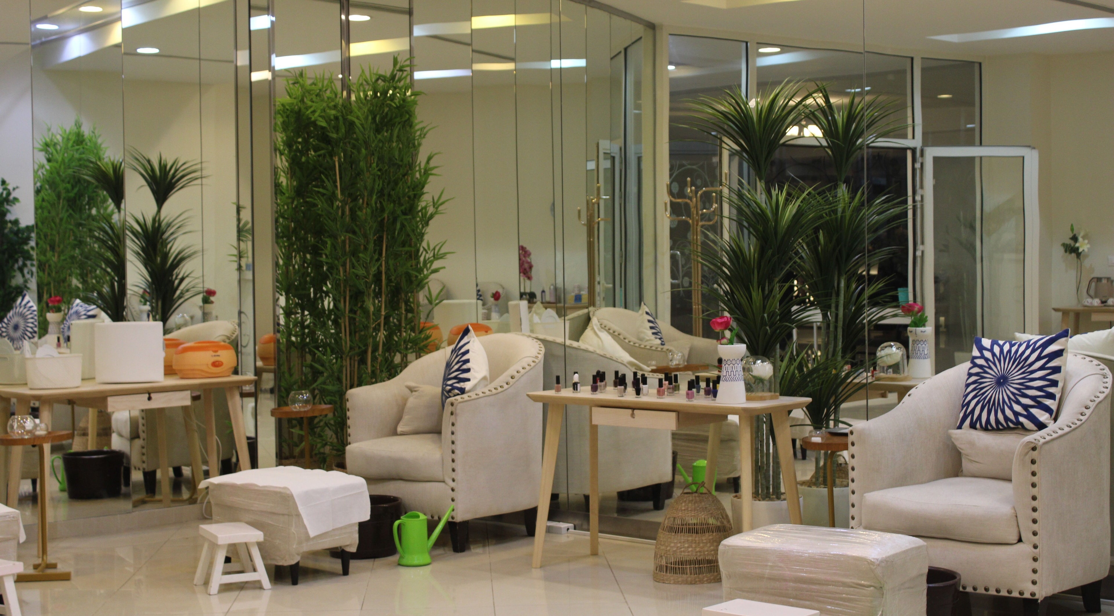 Elegant interior of Can Beauty Salon | Hayel, Hayel, SA, featuring plush chairs and vibrant greenery.
