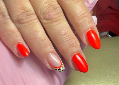 Stylish red manicure with leopard accent at Amore Nails & Beauty By Jayne, Birtley, England, GB.