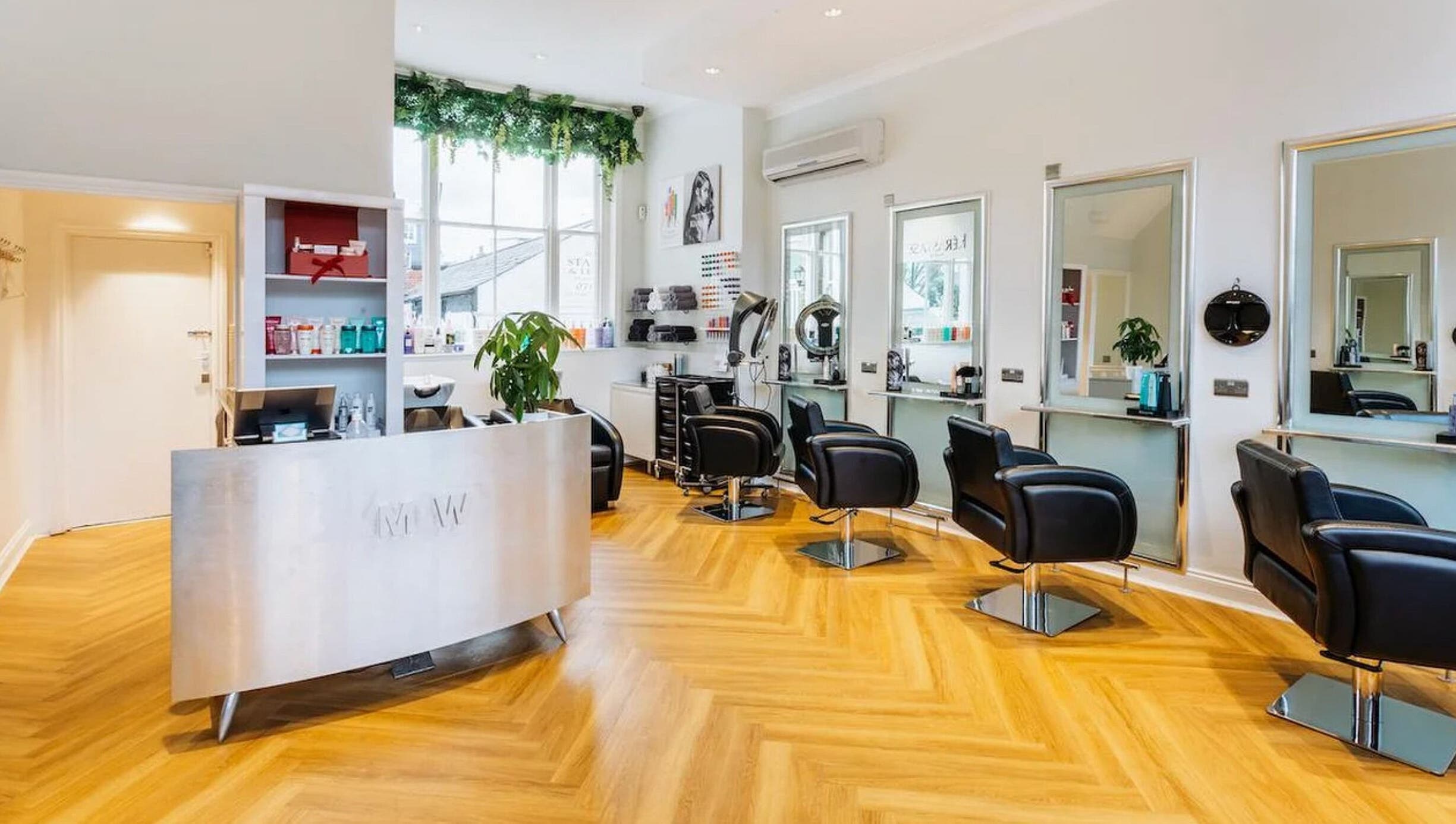 Modern, stylish interior of Making Waves Salon in London, England, GB with sleek chairs and bright lighting.