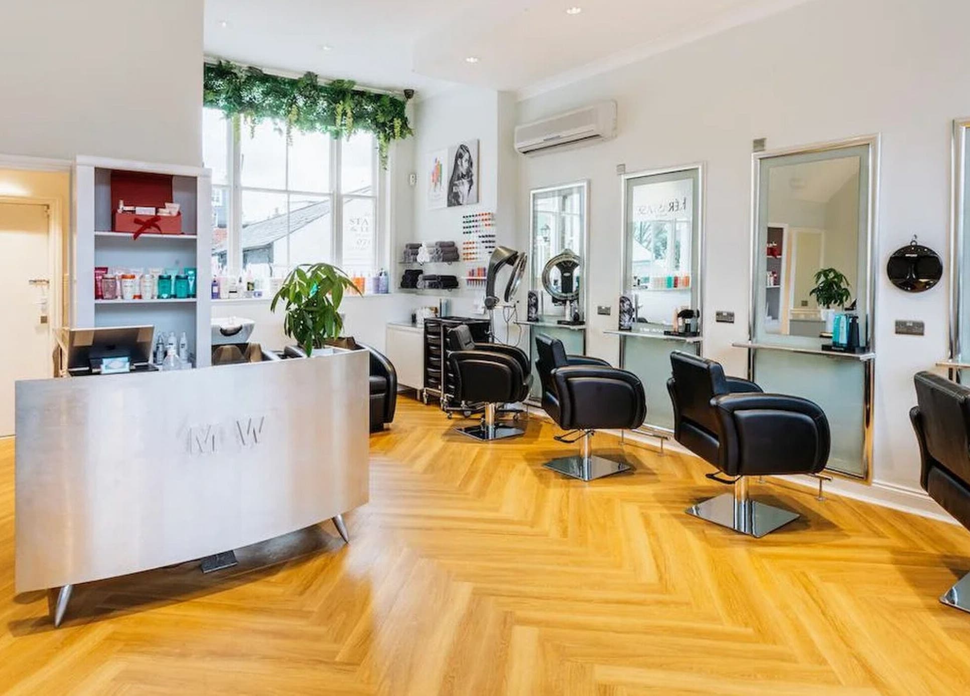 Modern, stylish interior of Making Waves Salon in London, England, GB with sleek chairs and bright lighting.