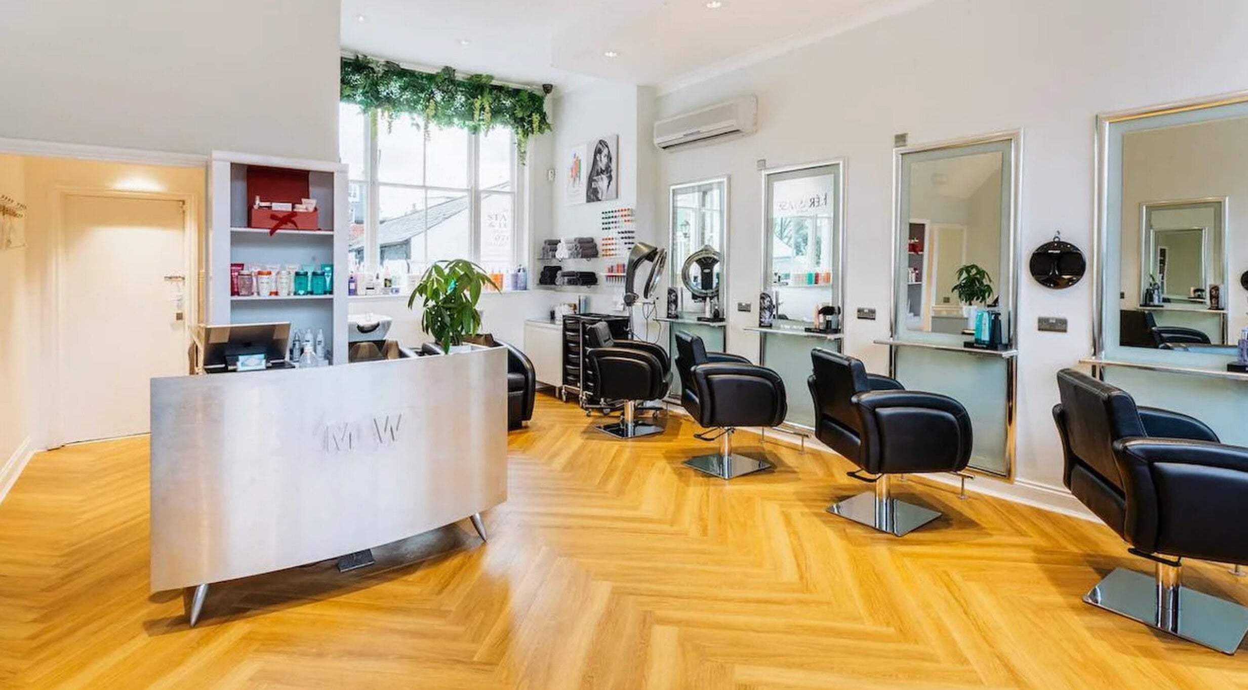 Modern, stylish interior of Making Waves Salon in London, England, GB with sleek chairs and bright lighting.