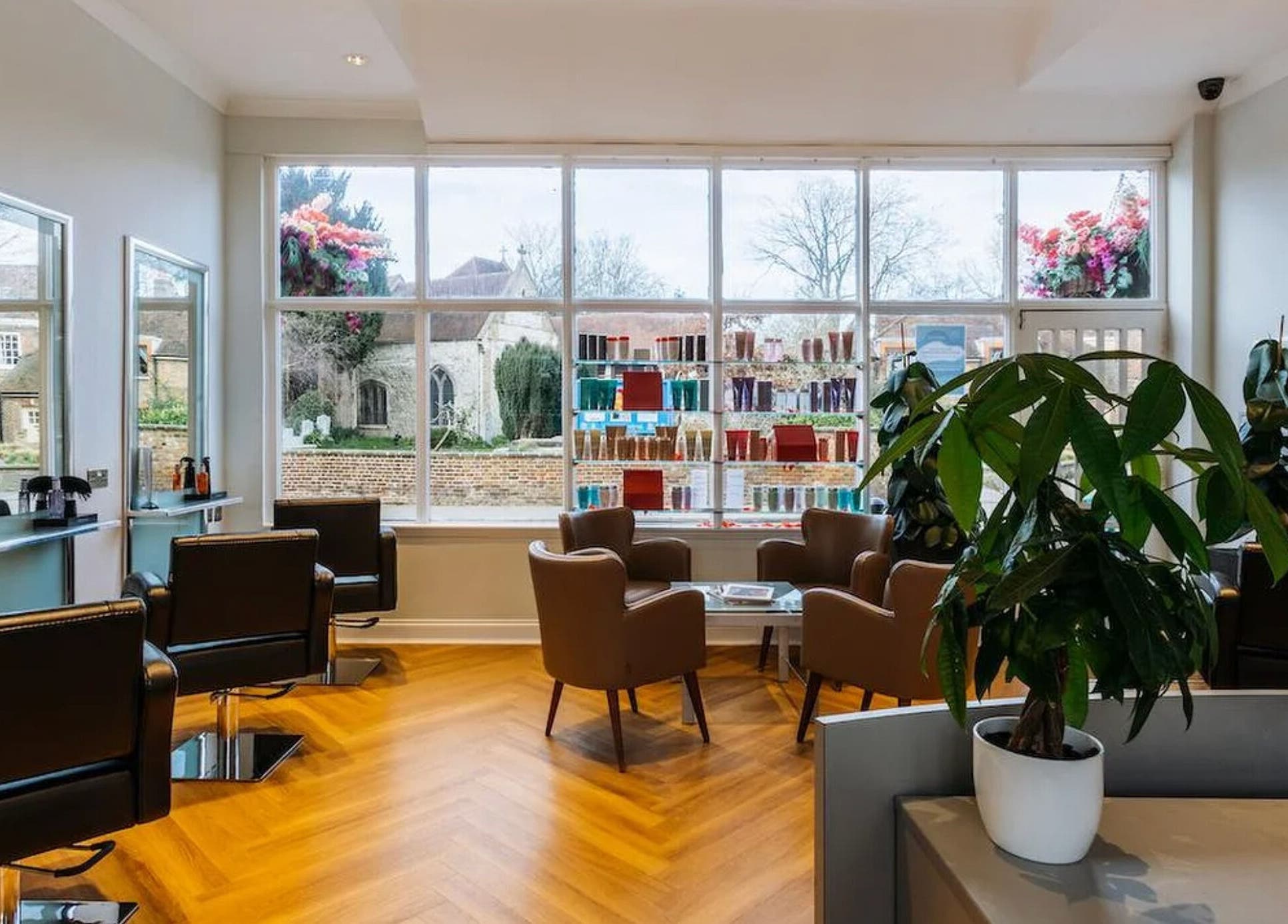Spacious and stylish interior of Making Waves Salon, London, England, GB with elegant seating and large windows.