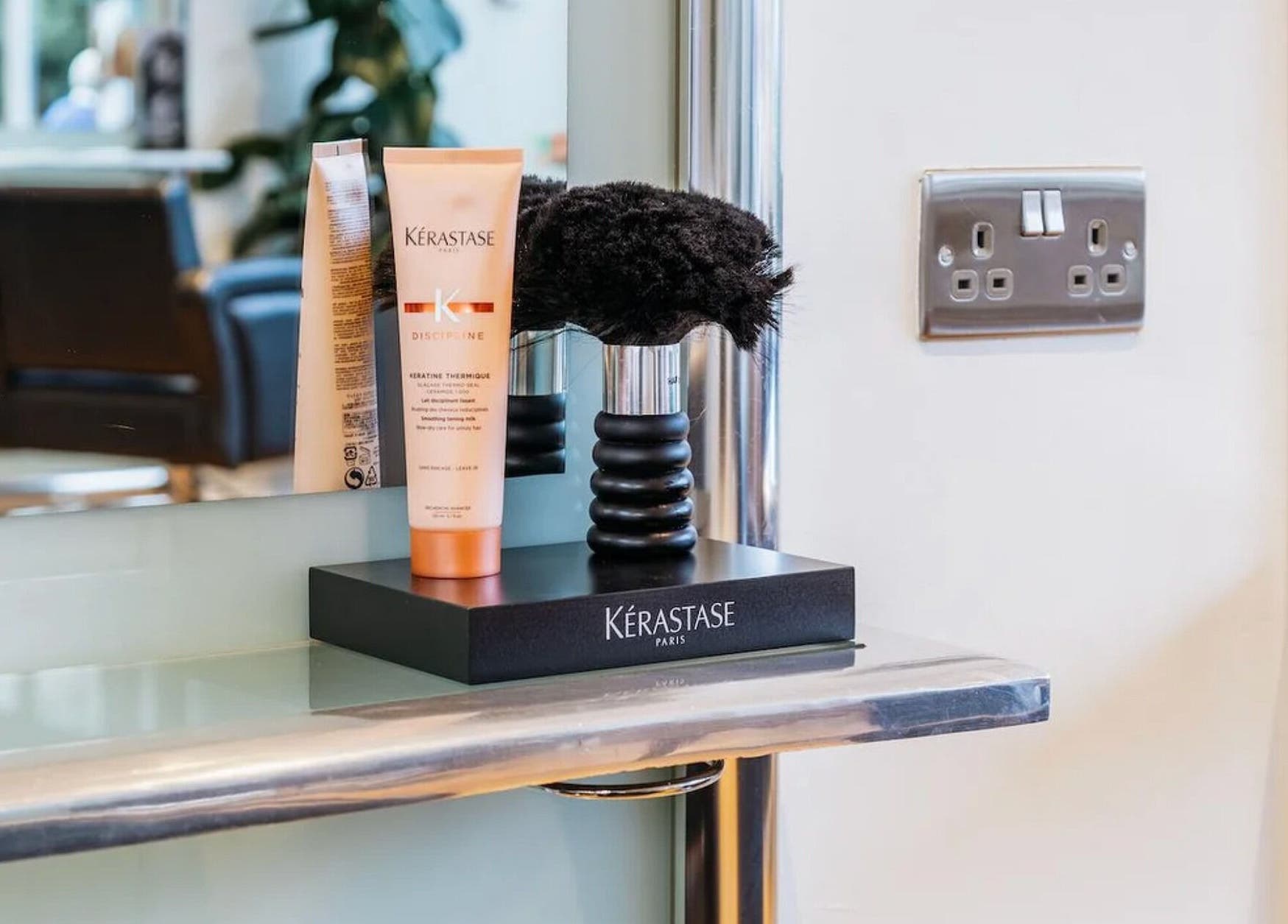 Hair styling station at Making Waves Salon, London, England, GB, featuring Kerastase products.