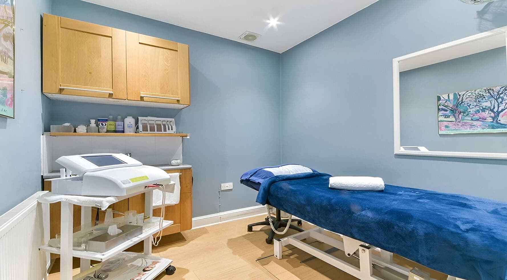BTS BEAUTY treatment room with blue decor and spa bed in London, England, GB.