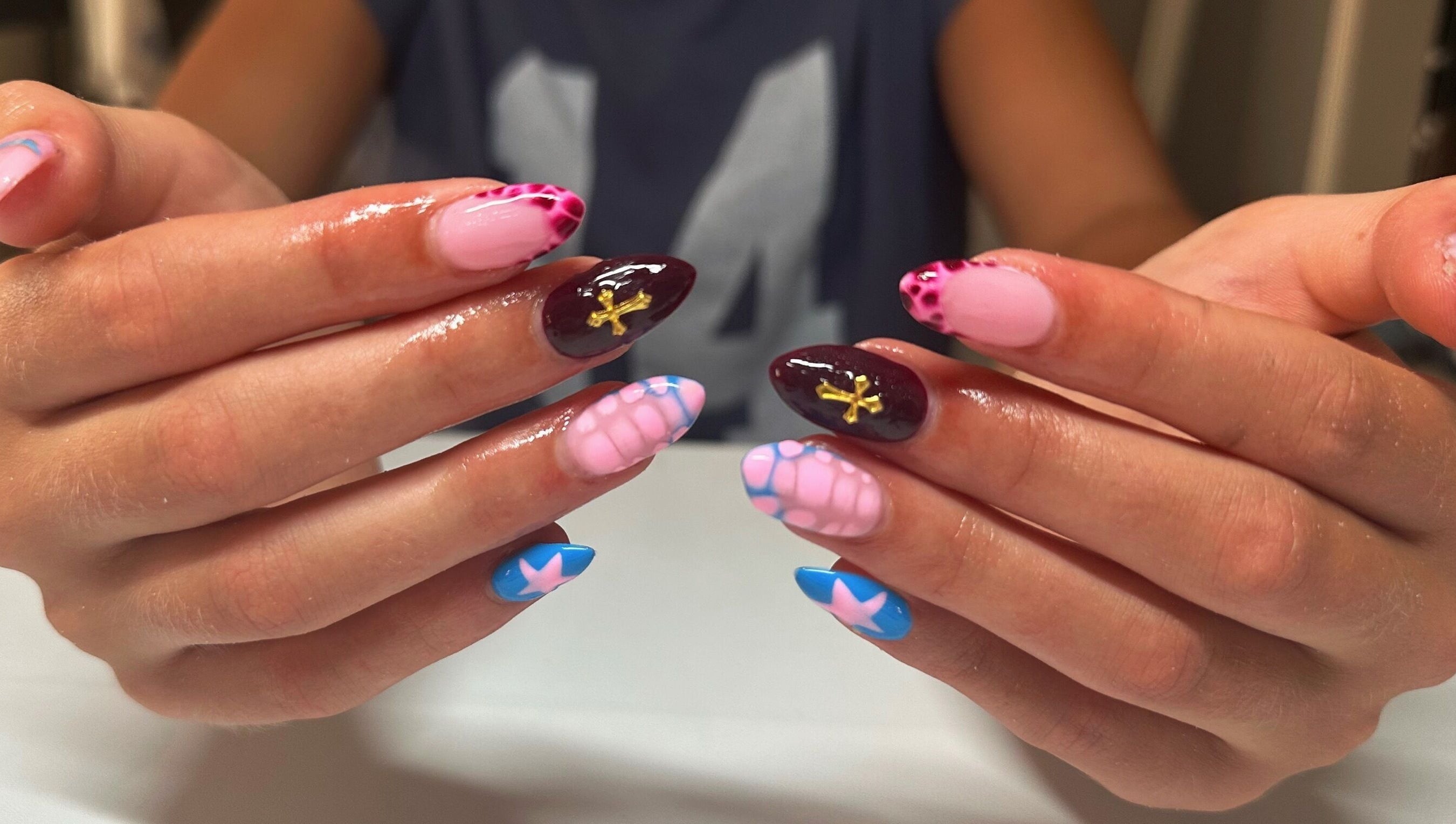 Colorful nail art design at Nails By Gabie in Bettendorf, Iowa, US, showcasing intricate patterns.