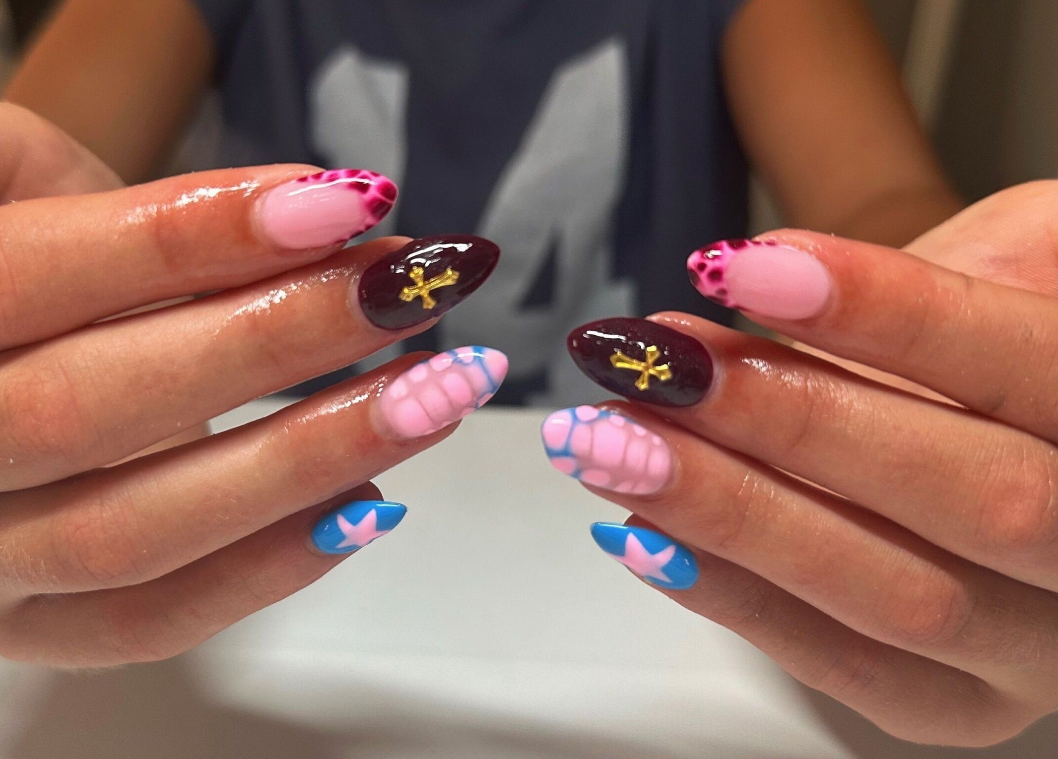 Colorful nail art design at Nails By Gabie in Bettendorf, Iowa, US, showcasing intricate patterns.