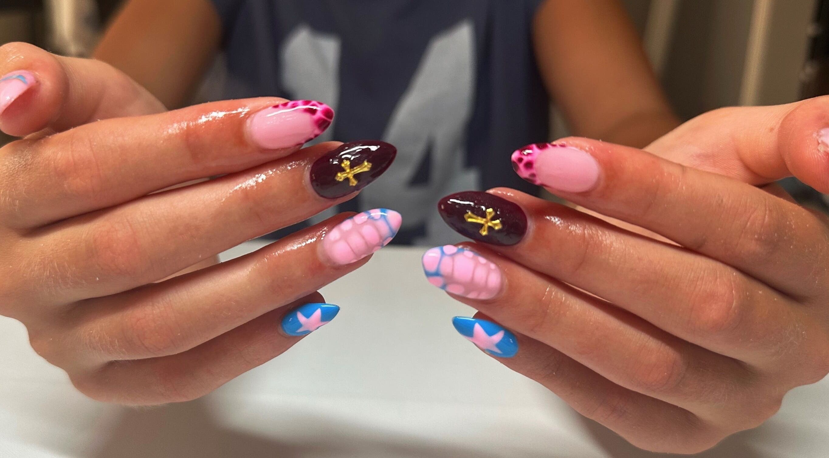 Colorful nail art design at Nails By Gabie in Bettendorf, Iowa, US, showcasing intricate patterns.