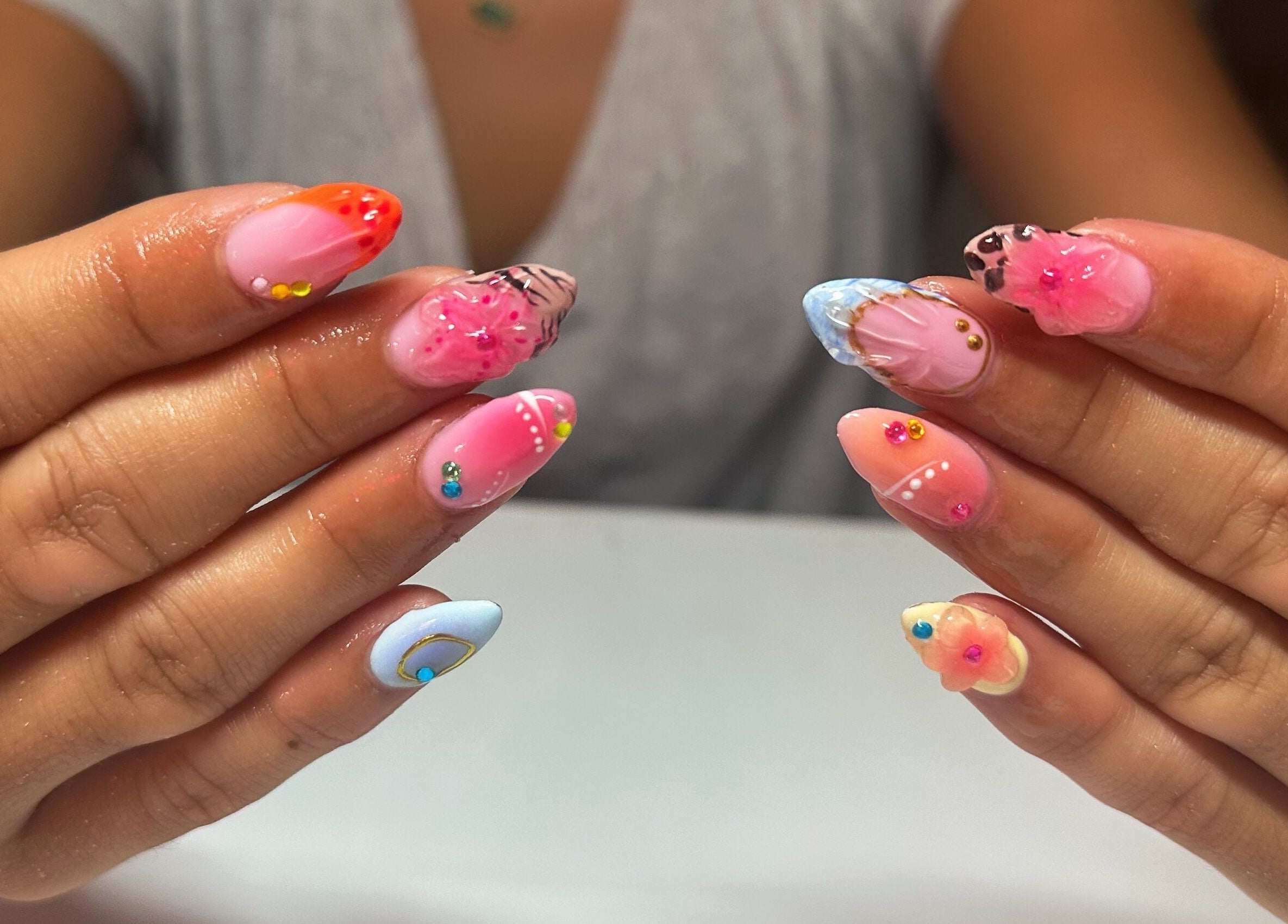 Colorful nail art at Nails By Gabie, Bettendorf, Iowa, US, showcasing vibrant designs and intricate details.