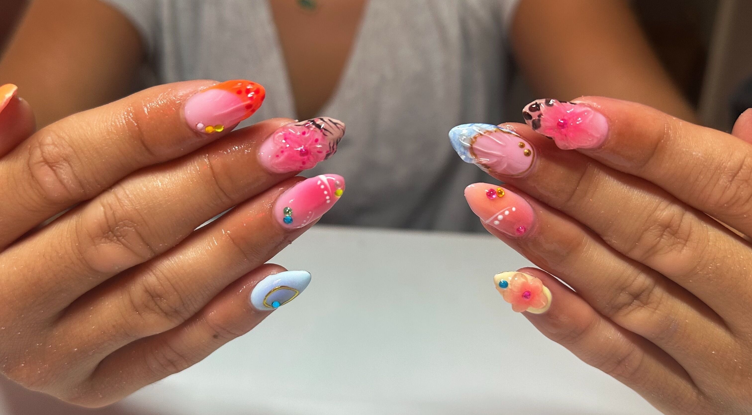Colorful nail art at Nails By Gabie, Bettendorf, Iowa, US, showcasing vibrant designs and intricate details.