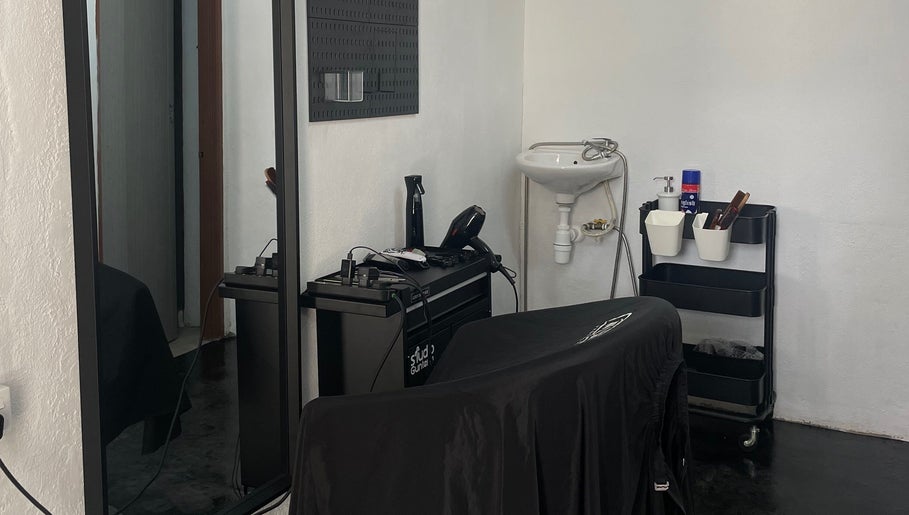 Modern salon interior at StudioGunteng, Cheras, Wilayah Persekutuan Kuala Lumpur, MY featuring elegant styling tools.