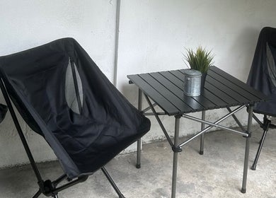 Outdoor seating at StudioGunteng, Cheras, Wilayah Persekutuan Kuala Lumpur, MY with black chairs and table.