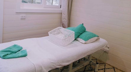 Relaxing massage bed at Nisa Massage Retreat, Urangan, Queensland, AU, showcasing tranquility and comfort.
