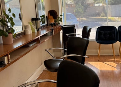 Modern interior of Hey Jude Hair Salon, Clearview, South Australia with sleek chairs and vibrant decor.