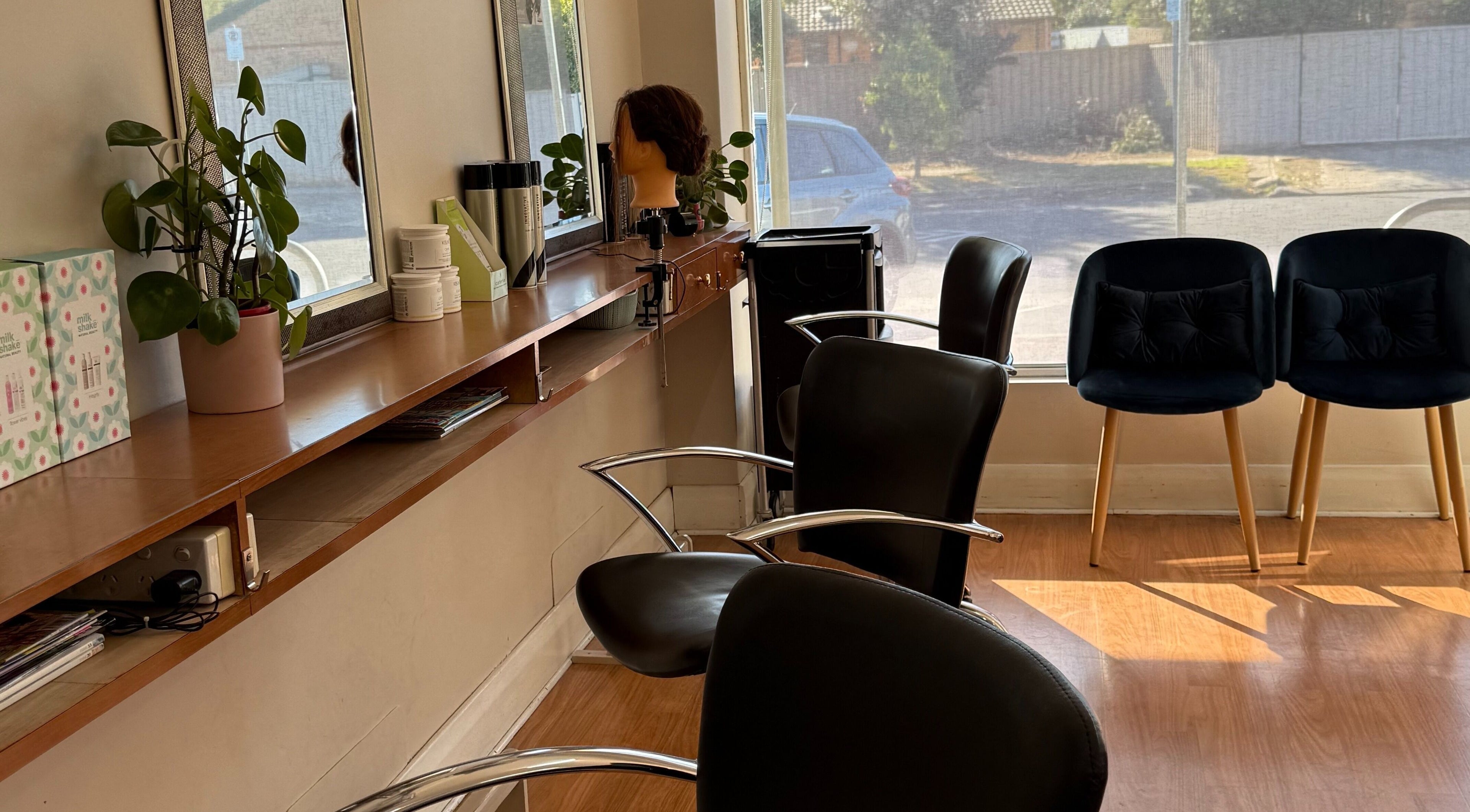 Modern interior of Hey Jude Hair Salon, Clearview, South Australia with sleek chairs and vibrant decor.