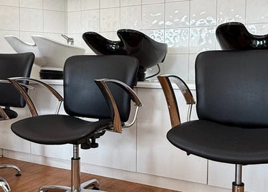 Modern black salon chairs and sinks at Hey Jude Hair Salon in Clearview, South Australia, AU.