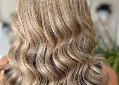 Elegant wavy blonde hairstyle at Hey Jude Hair Salon, Clearview, South Australia, AU.