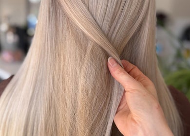 Close-up of sleek blonde hair being styled at Hey Jude Hair Salon, Clearview, South Australia, AU.