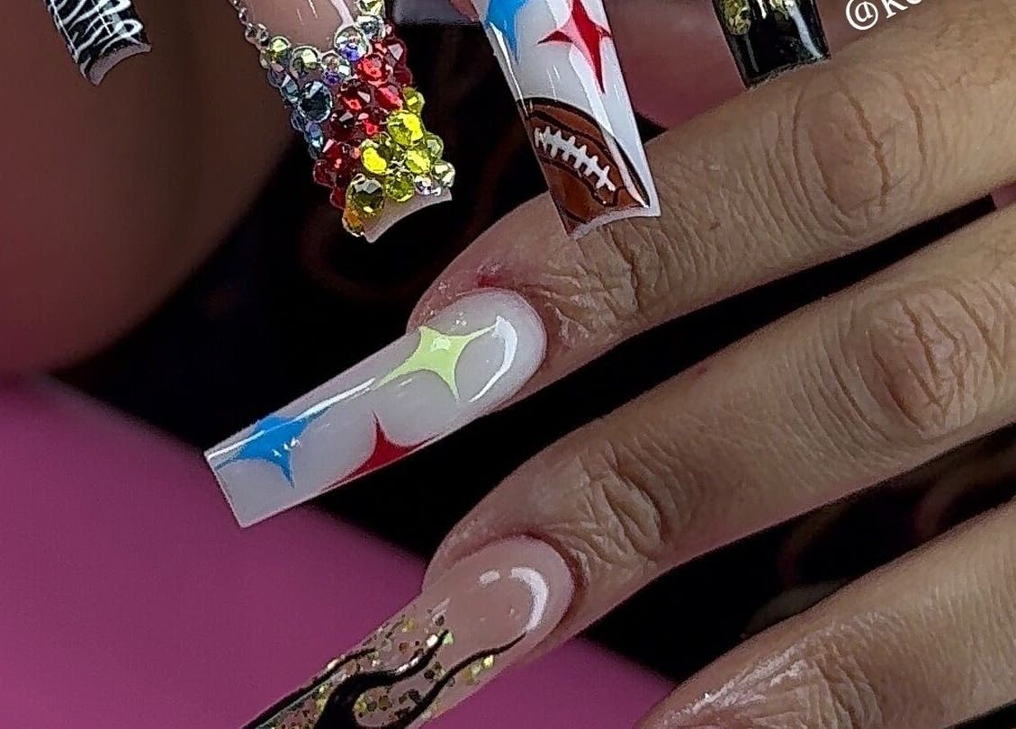 Vibrant nail art at Kayden Luong in Atlanta, Georgia, US, featuring colorful gems and unique designs.