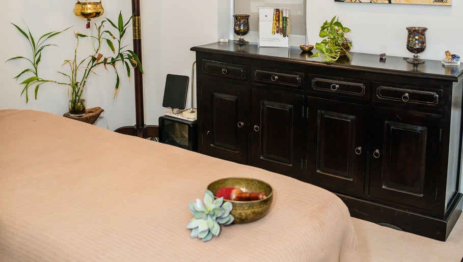 Tranquil massage room at Kundalini Temple in Kellyville, New South Wales, AU with bed and plants.