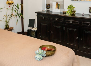 Tranquil massage room at Kundalini Temple in Kellyville, New South Wales, AU with bed and plants.