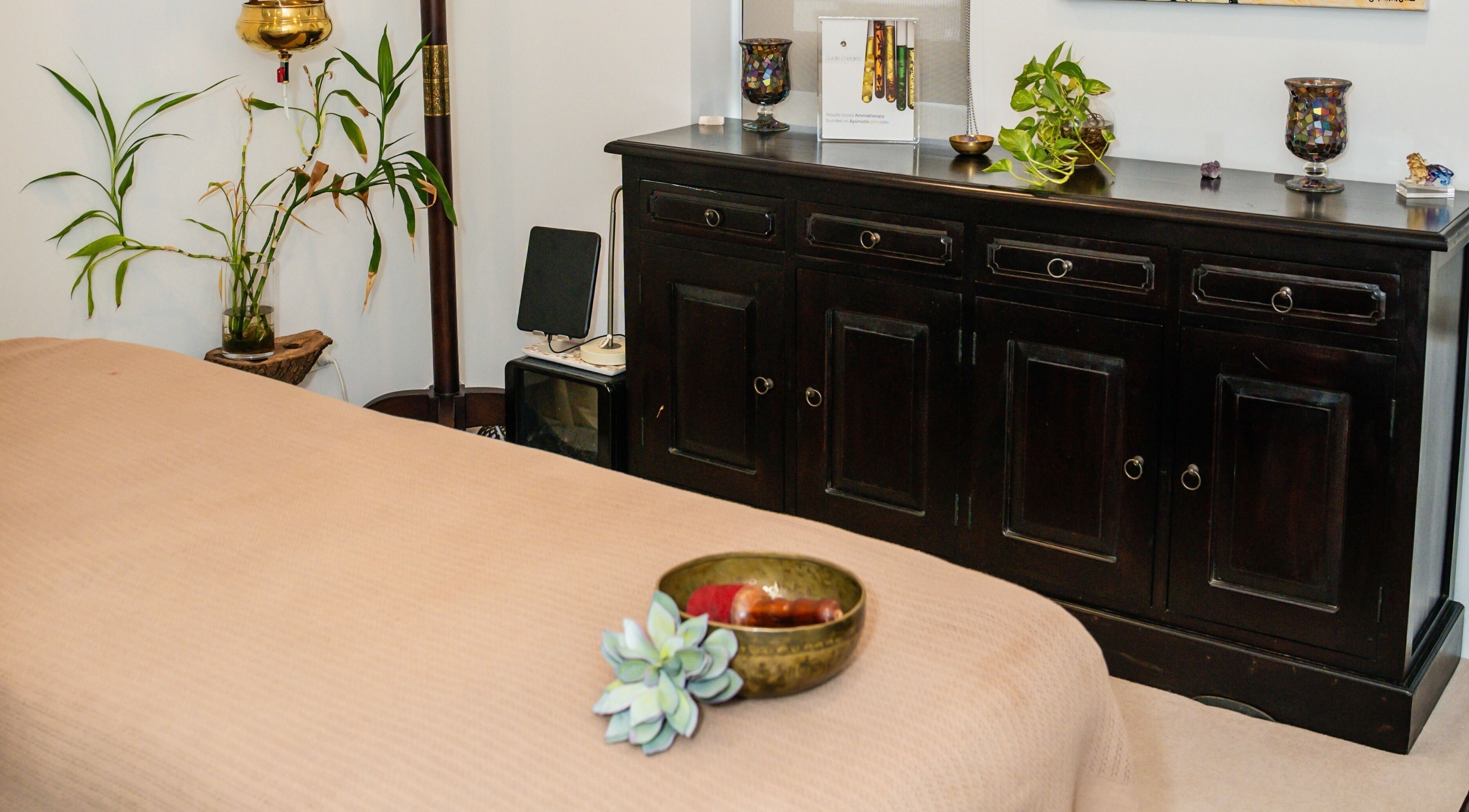 Tranquil massage room at Kundalini Temple in Kellyville, New South Wales, AU with bed and plants.