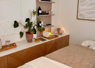 Tranquil massage room at AR Massage Therapy, Leeds, England, GB. Cozy bed, plants, and soft lighting set a relaxing mood.