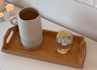 Relaxing setup at AR Massage Therapy, Leeds, England, GB featuring a pitcher and candles on a wooden tray.