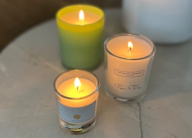 Lit candles on a marble surface at AR Massage Therapy, Leeds, England, GB, creating a tranquil ambiance.