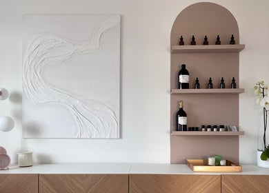 Chic shelves and decor at AR Massage Therapy, Leeds, England, GB, featuring essential oils and modern art.