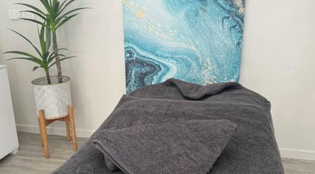 Tranquil massage room at Massage Relax Restore Townsville, Garbutt, Queensland, AU with calming decor and plant.
