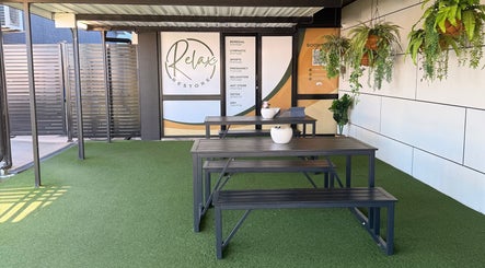 Outdoor seating area at Massage Relax Restore Townsville in Garbutt, Queensland, AU with greenery and elegance.