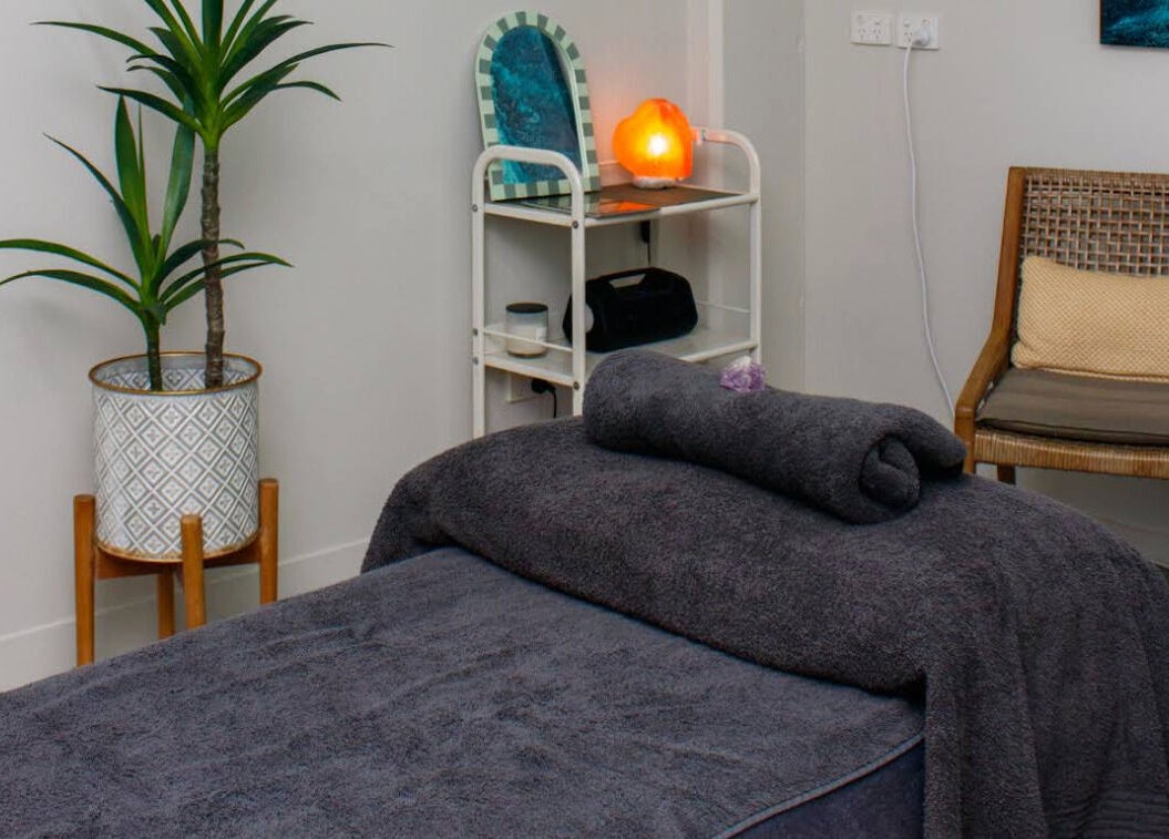Serene massage room at Massage Relax Restore Townsville in Garbutt, Queensland, AU, featuring cozy decor.