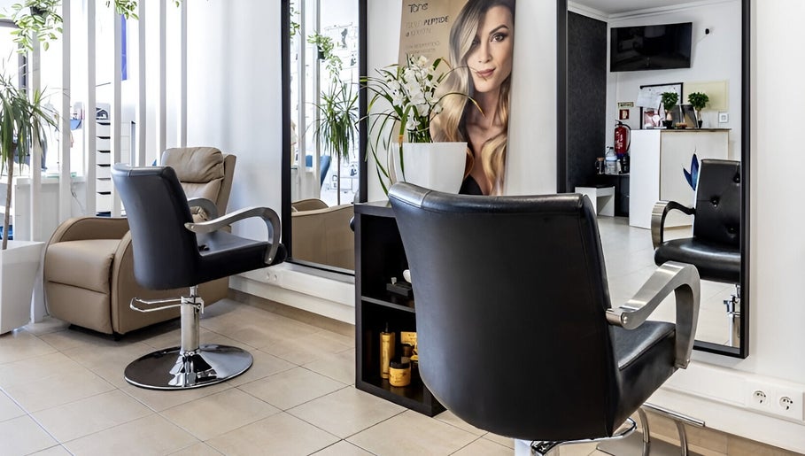 Sleek styling chairs and modern decor at Luxe Hair by Kamal in Lagos, Faro, PT.