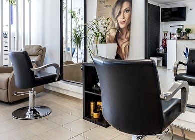 Sleek styling chairs and modern decor at Luxe Hair by Kamal in Lagos, Faro, PT.