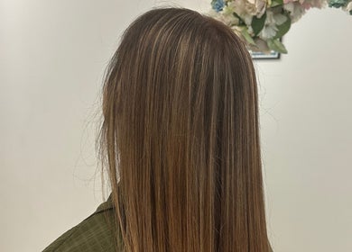 Sleek, brown straight hair styled at Luxe Hair by Kamal, Lagos, Faro, PT, showcasing expert salon work.