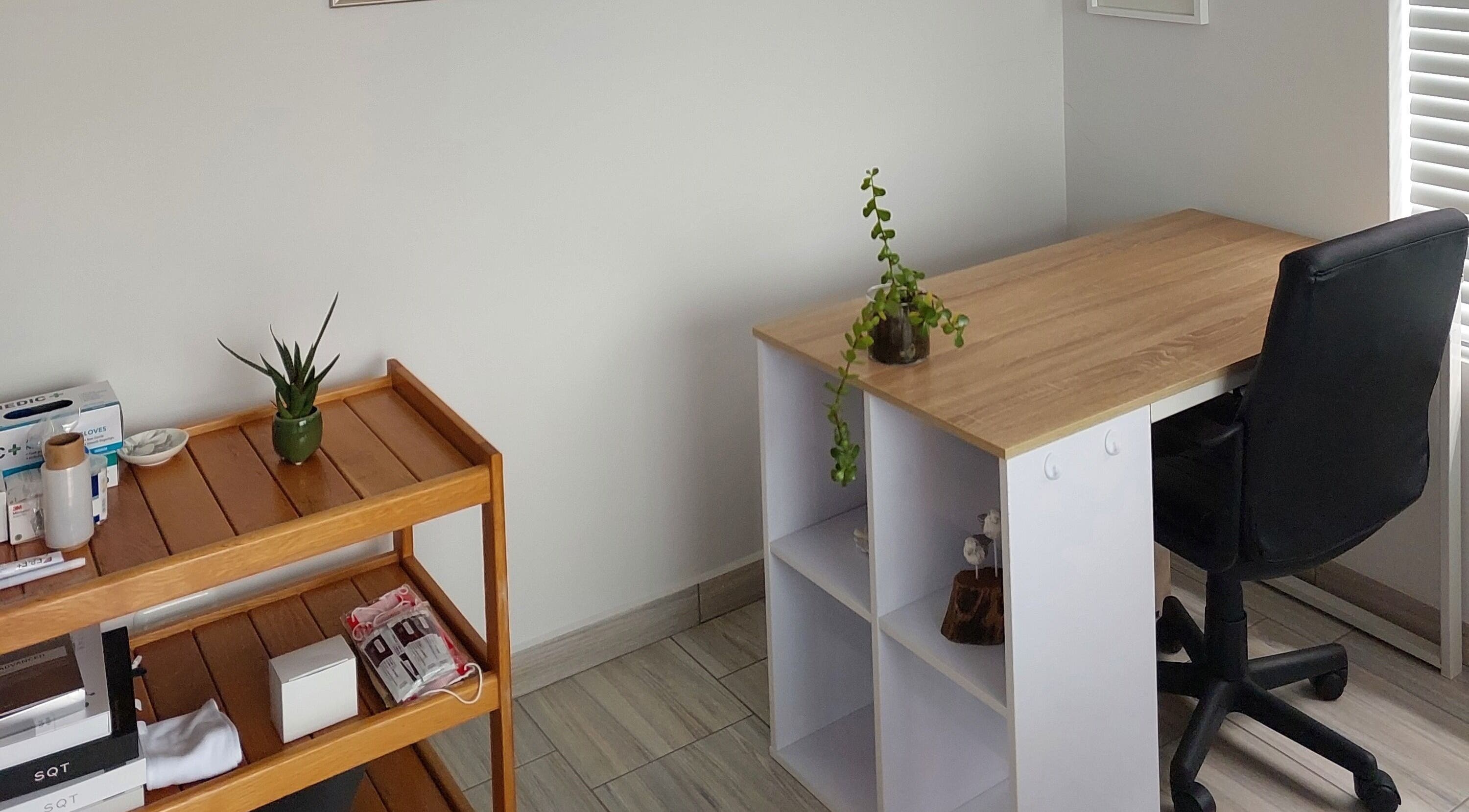 Calm, minimalist workspace at Blooms, Jeffreys Bay, Eastern Cape, ZA with desk and plant for relaxation.