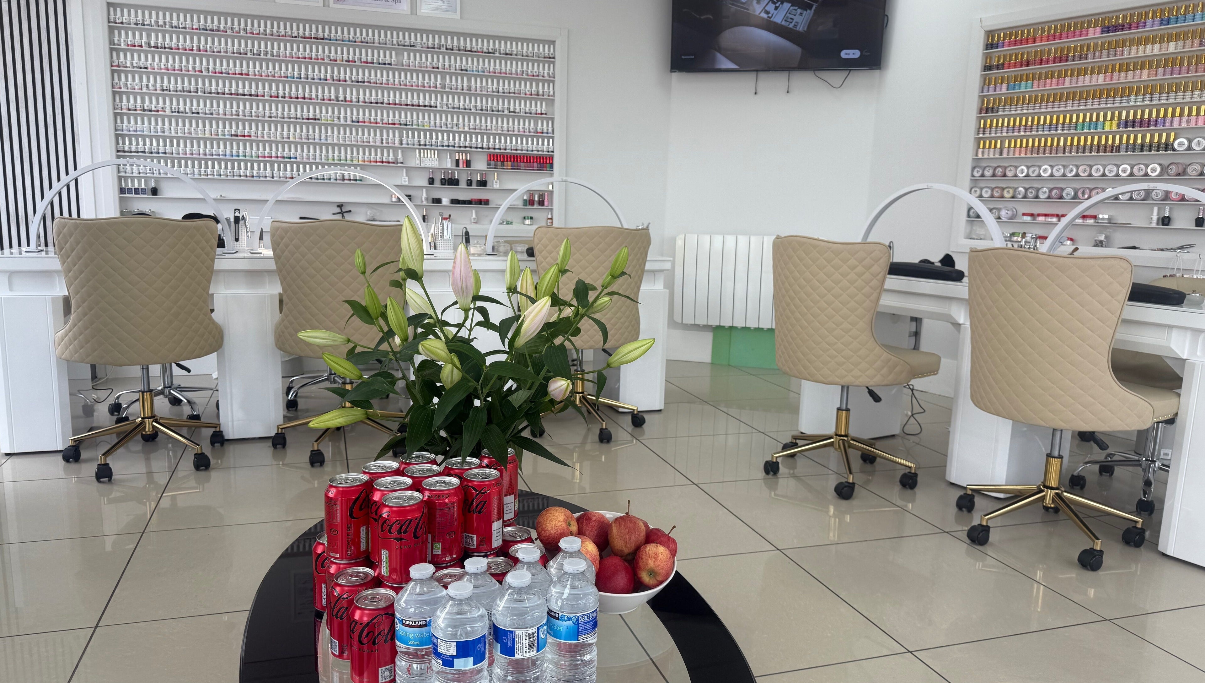 Lux Nails & Spa in Carluke, Scotland, GB, showcasing a chic nail bar with refreshments and decor.