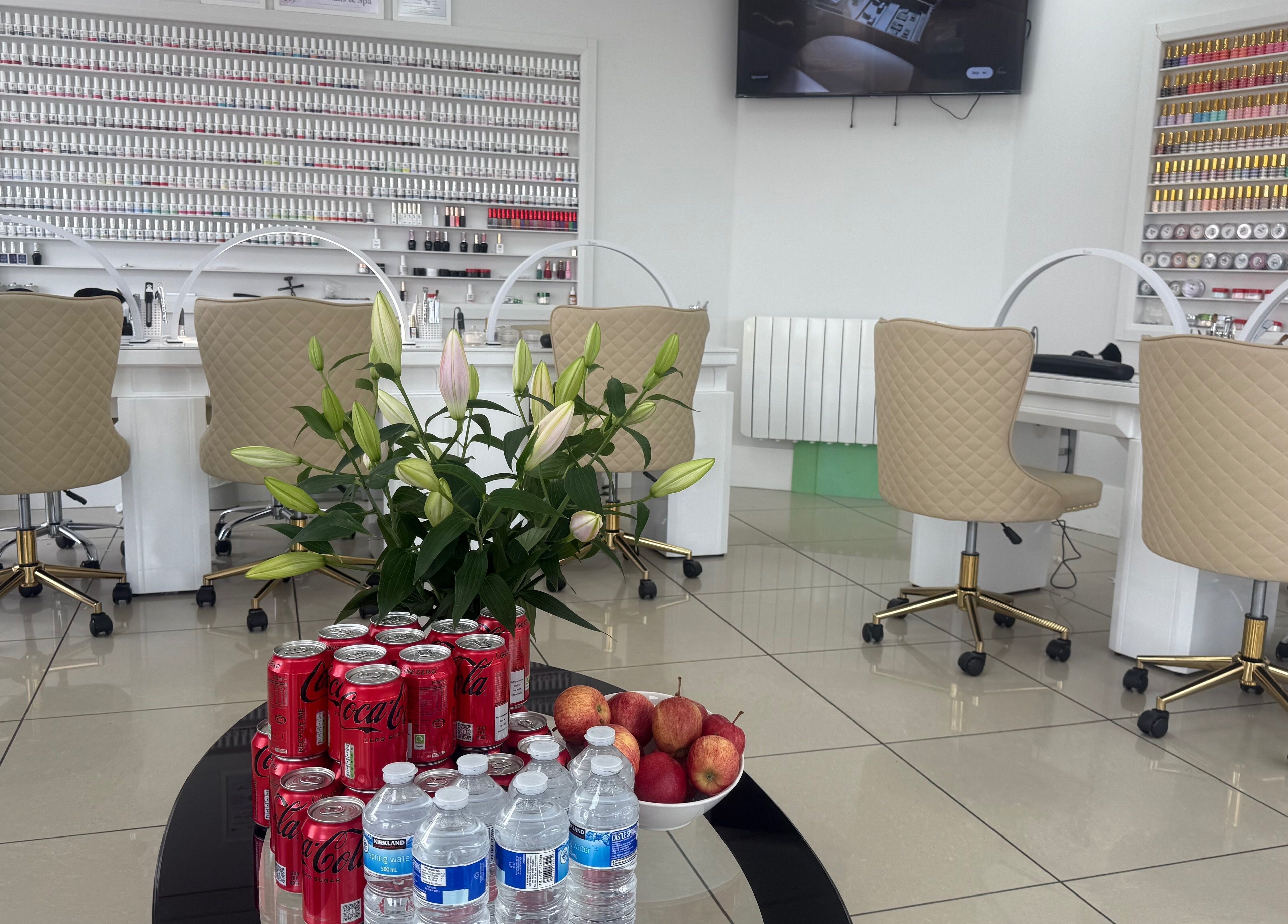 Lux Nails & Spa in Carluke, Scotland, GB, showcasing a chic nail bar with refreshments and decor.