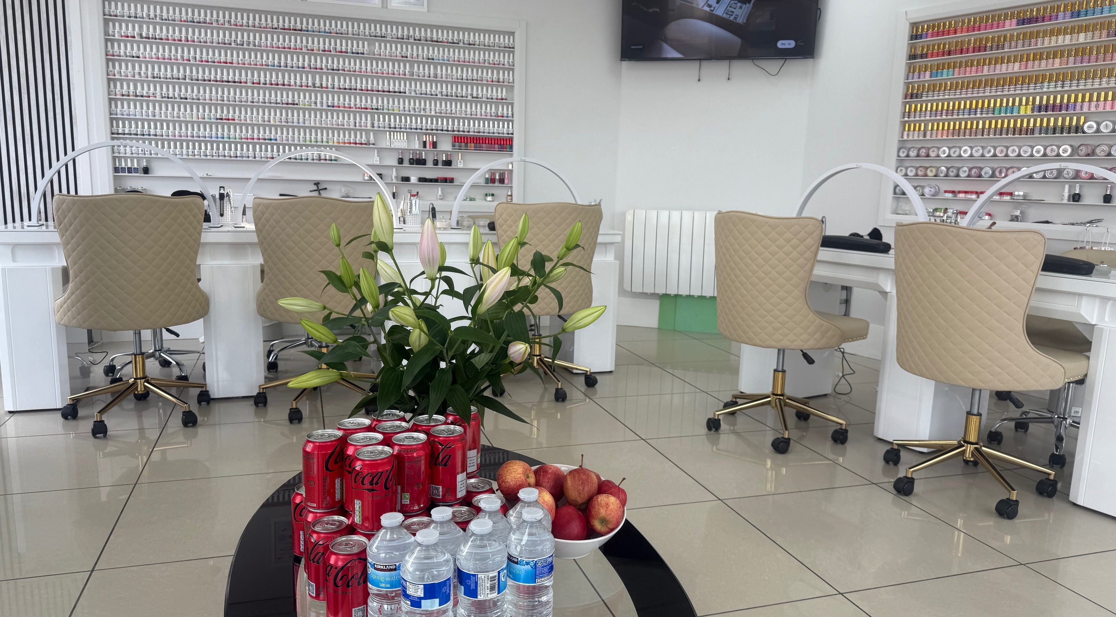 Lux Nails & Spa in Carluke, Scotland, GB, showcasing a chic nail bar with refreshments and decor.