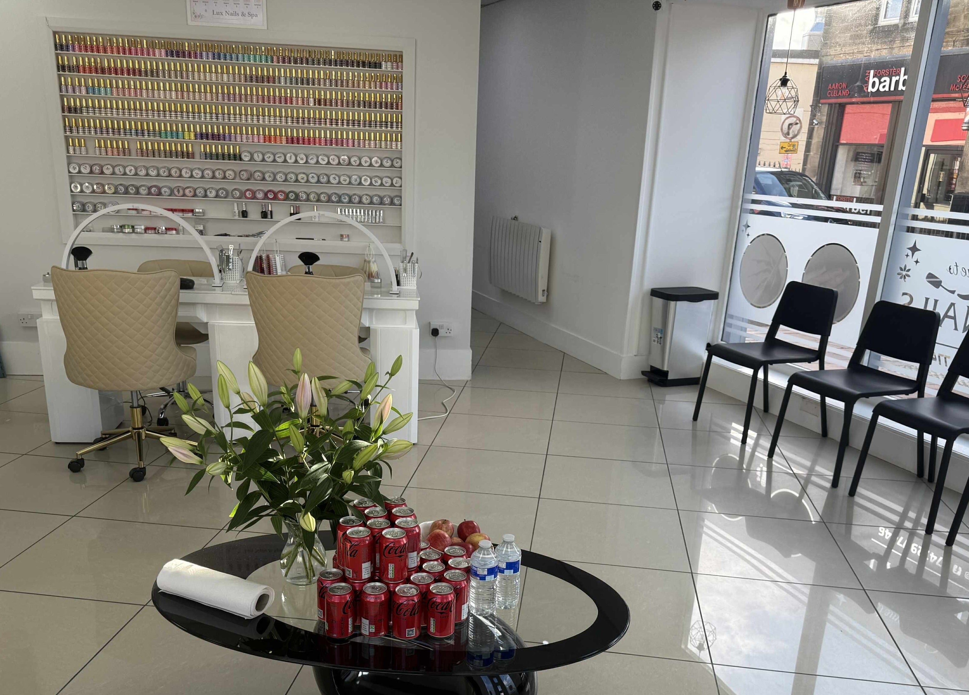 Lux Nails & Spa Carluke interior showcasing stylish seating and nail polish wall, in Carluke, Scotland, GB.
