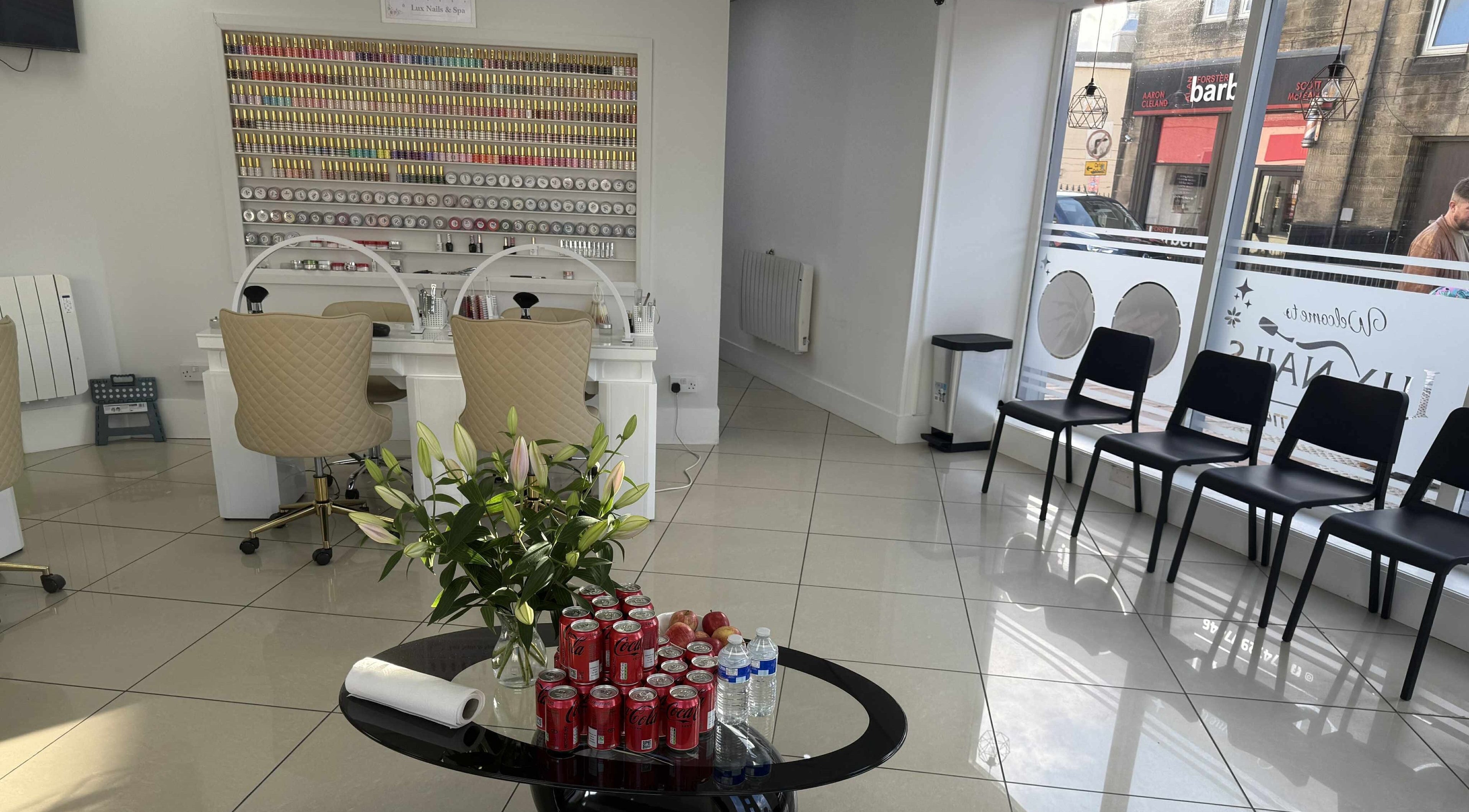 Lux Nails & Spa Carluke interior showcasing stylish seating and nail polish wall, in Carluke, Scotland, GB.