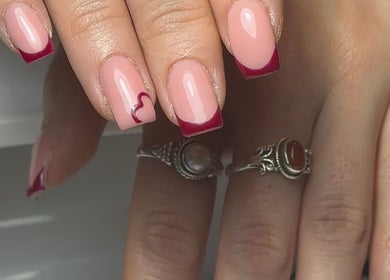 Chic nail art with red tips and heart design at Keexbeauty, Newport, Wales, GB.