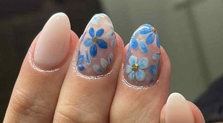 Elegant floral nail design at Leaf of Faith Beauty, Benoni, Gauteng, ZA, showcasing intricate blue flowers.