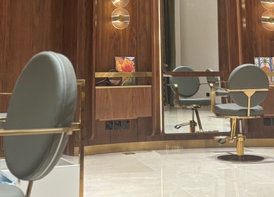 Luxurious salon chair at The Outré, Riyadh, Riyadh Province, SA with polished wood and modern lighting.