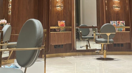 Luxurious salon chair at The Outré, Riyadh, Riyadh Province, SA with polished wood and modern lighting.